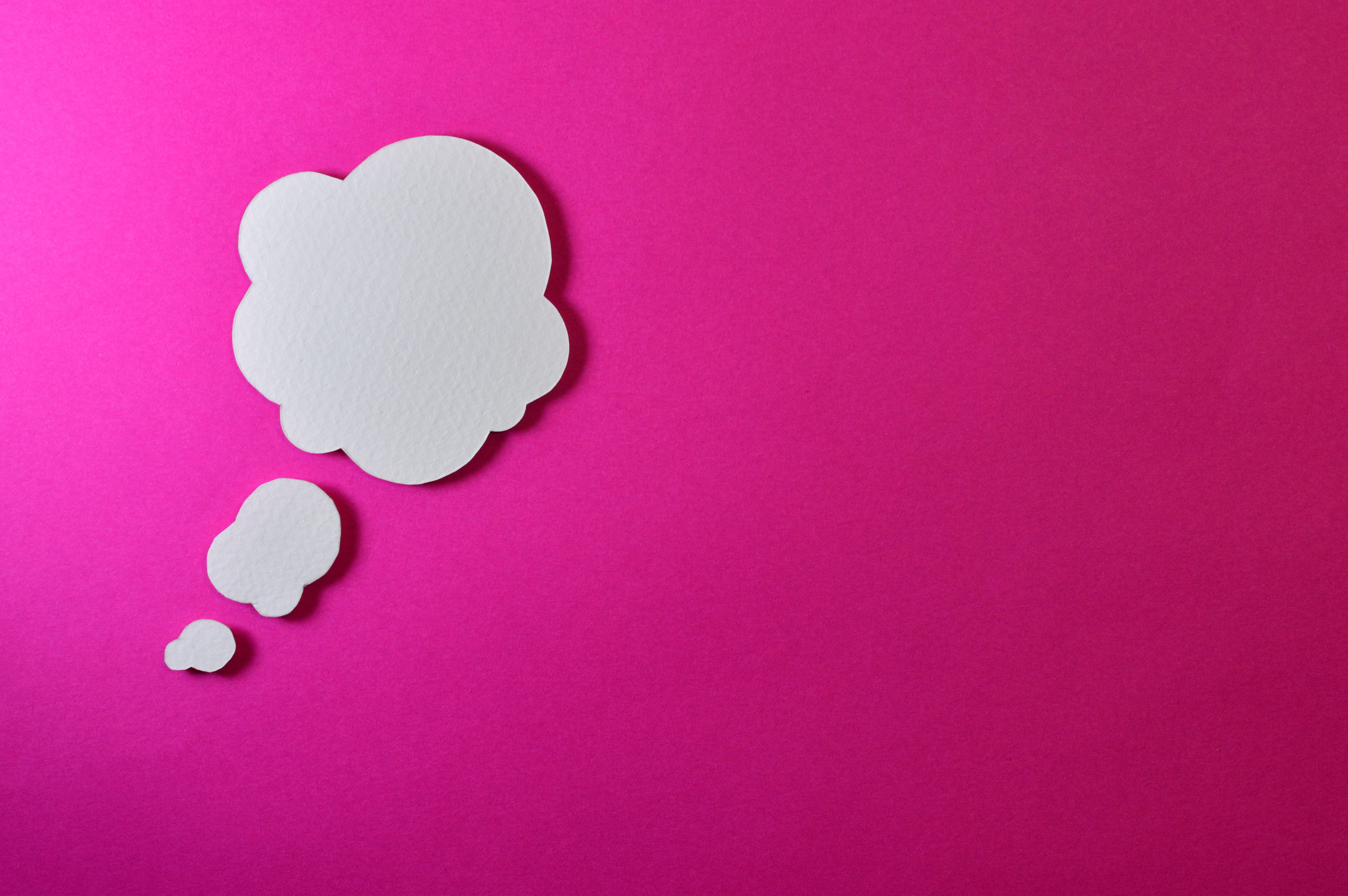 Thought cloud bubble on a pink background