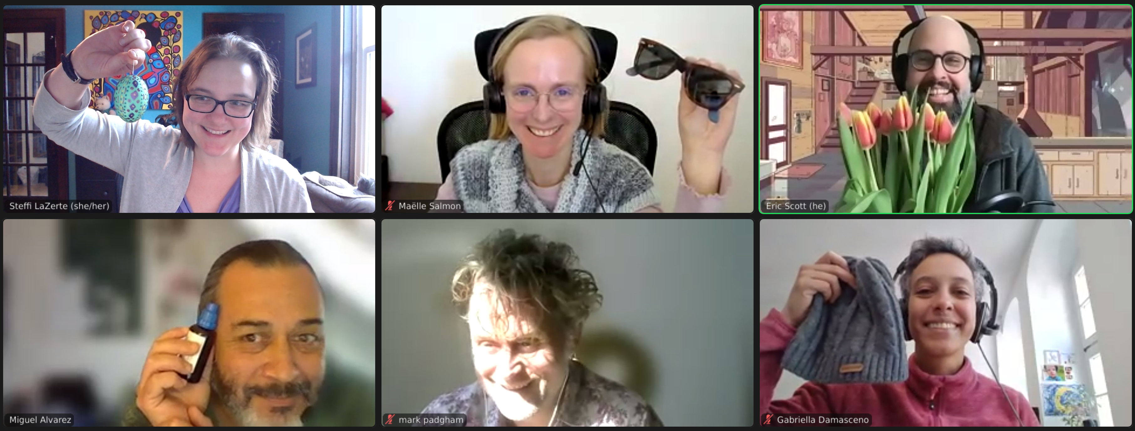A screenshot of a Zoom meeting showing 6 different video participants each holding something different: Decorated Easter egg, Sunglasses, Tulips, Allergy medicine, Sunbeam, and Touque*